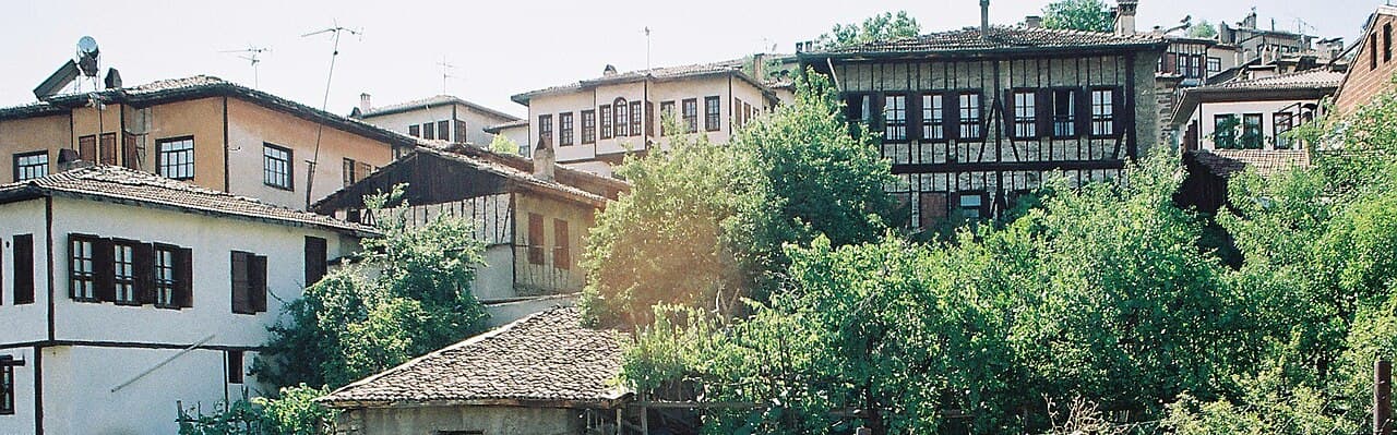 Timber-framed Ottoman white mansions and terracotta roofs of Safranbolu nestled in the deep river ravine