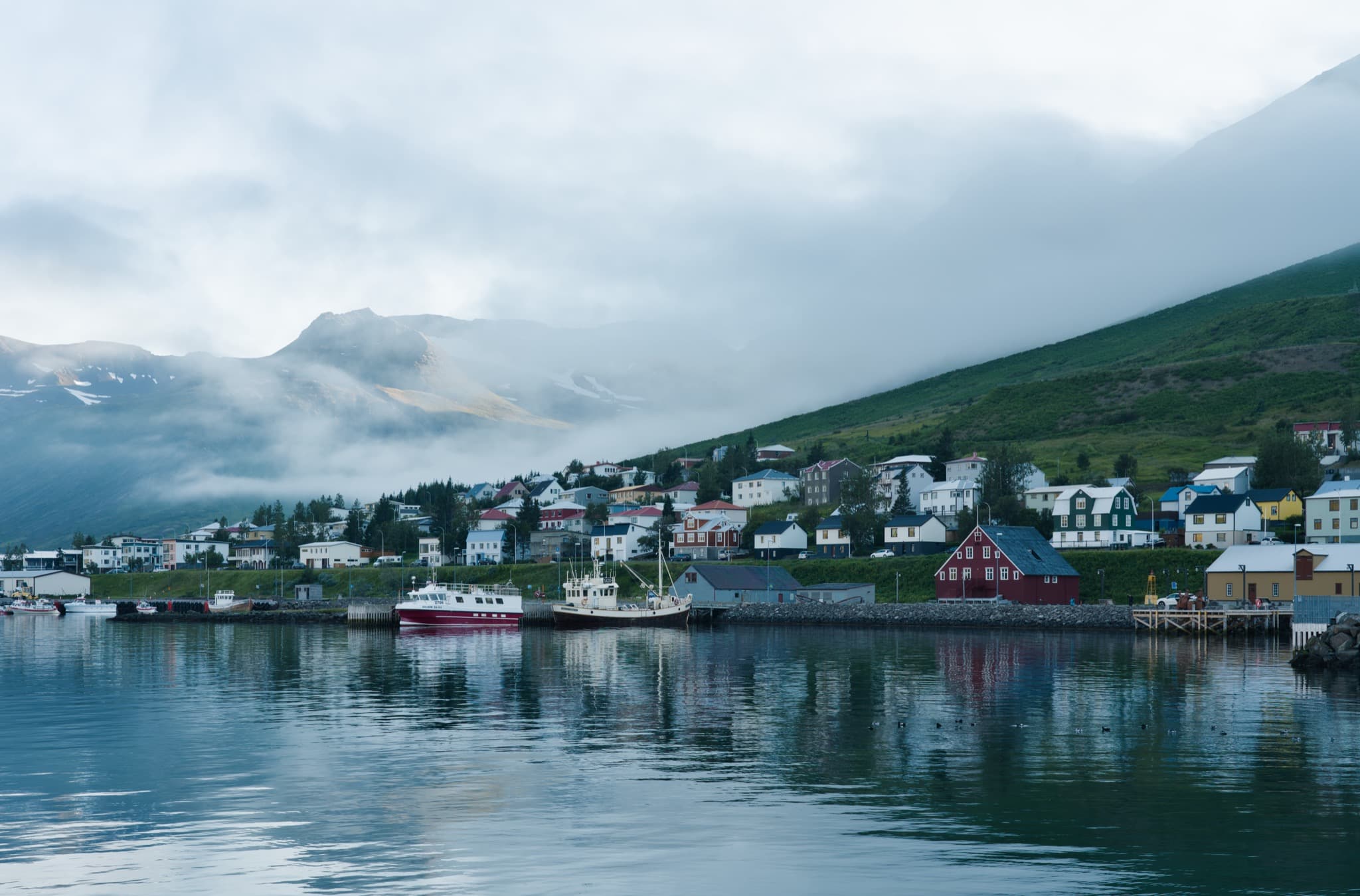 Colourful harbour warehouses and sheer fjord mountains of Siglufjörður on the Tröllaskagi peninsula