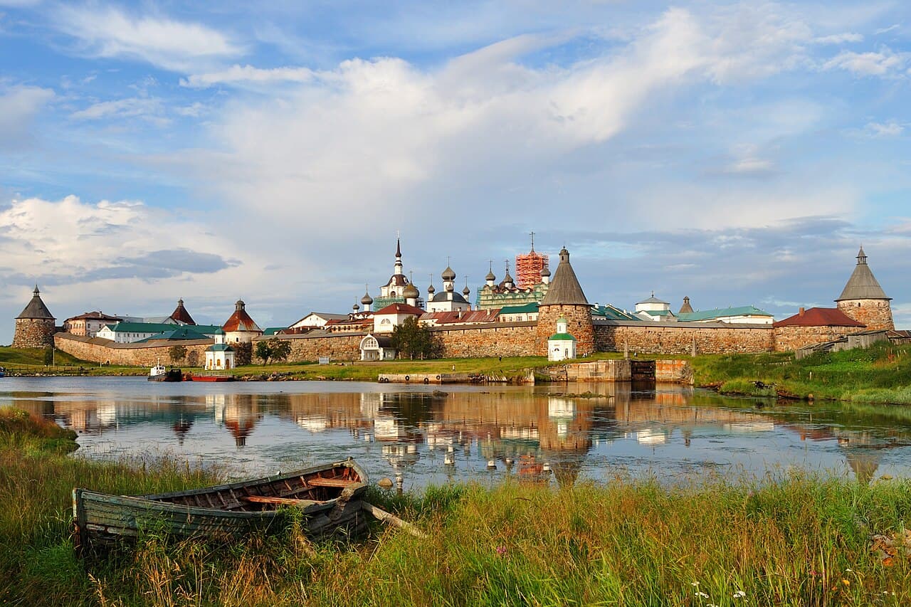 Boulder walls and towers of the Solovetsky Monastery reflected in the water