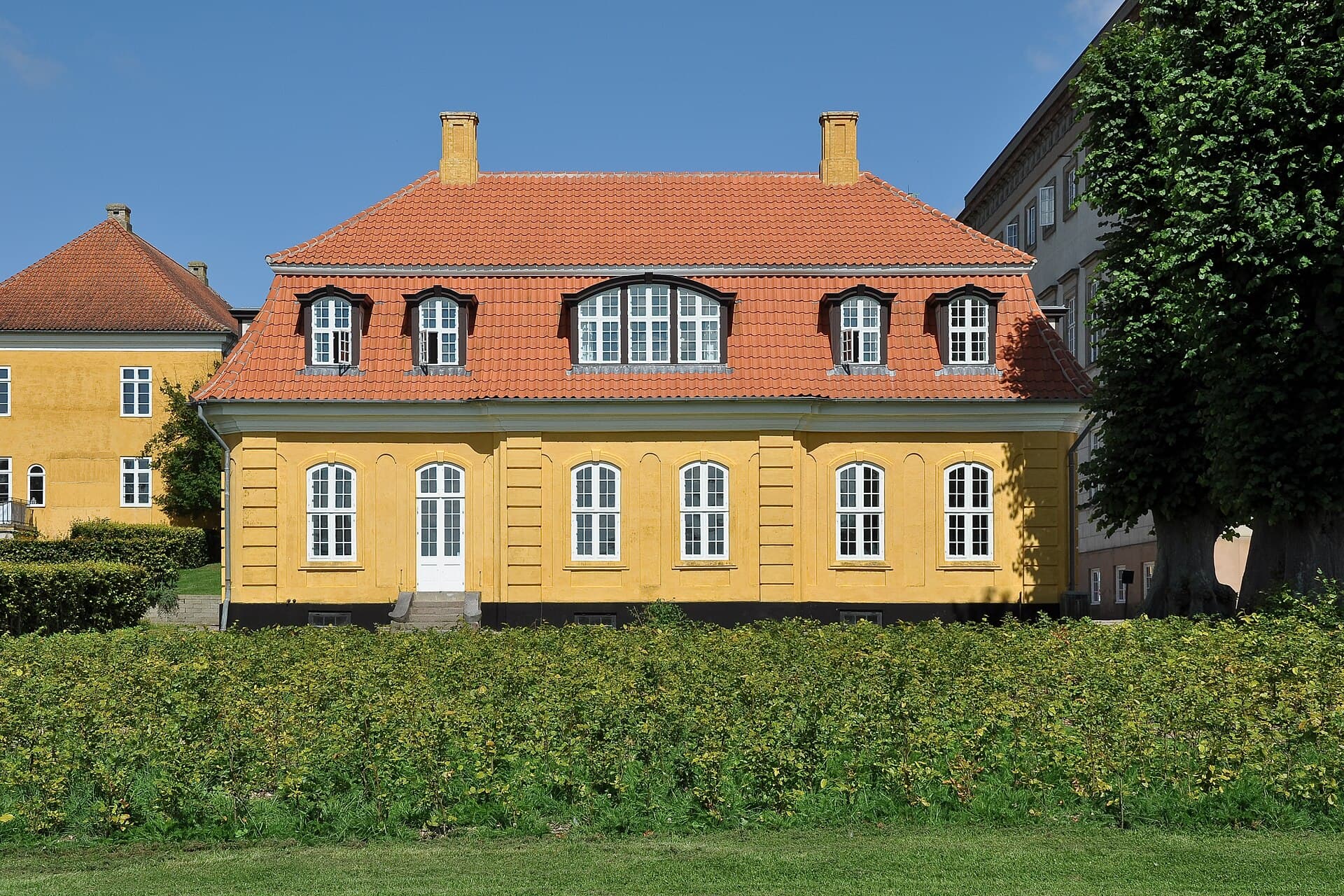 Historic neoclassical and timber buildings of Sorø Academy surrounded by Lake Sorø in West Zealand.