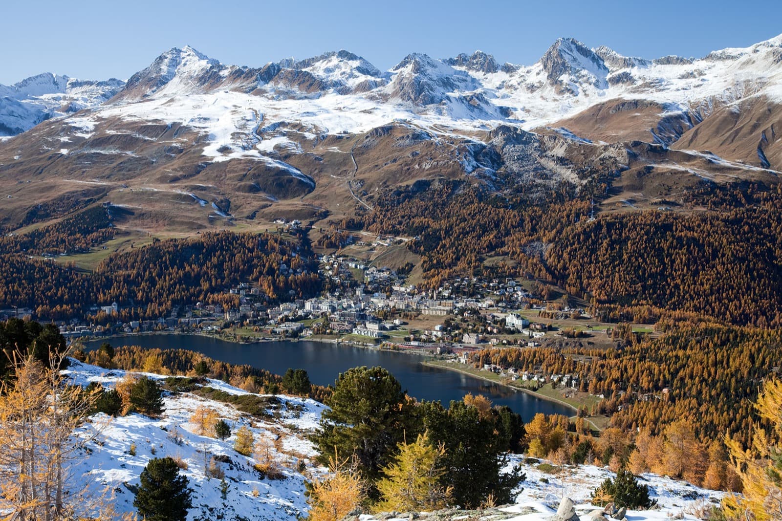 Alpine lake of St. Moritz framed by towering peaks of the Engadin valley