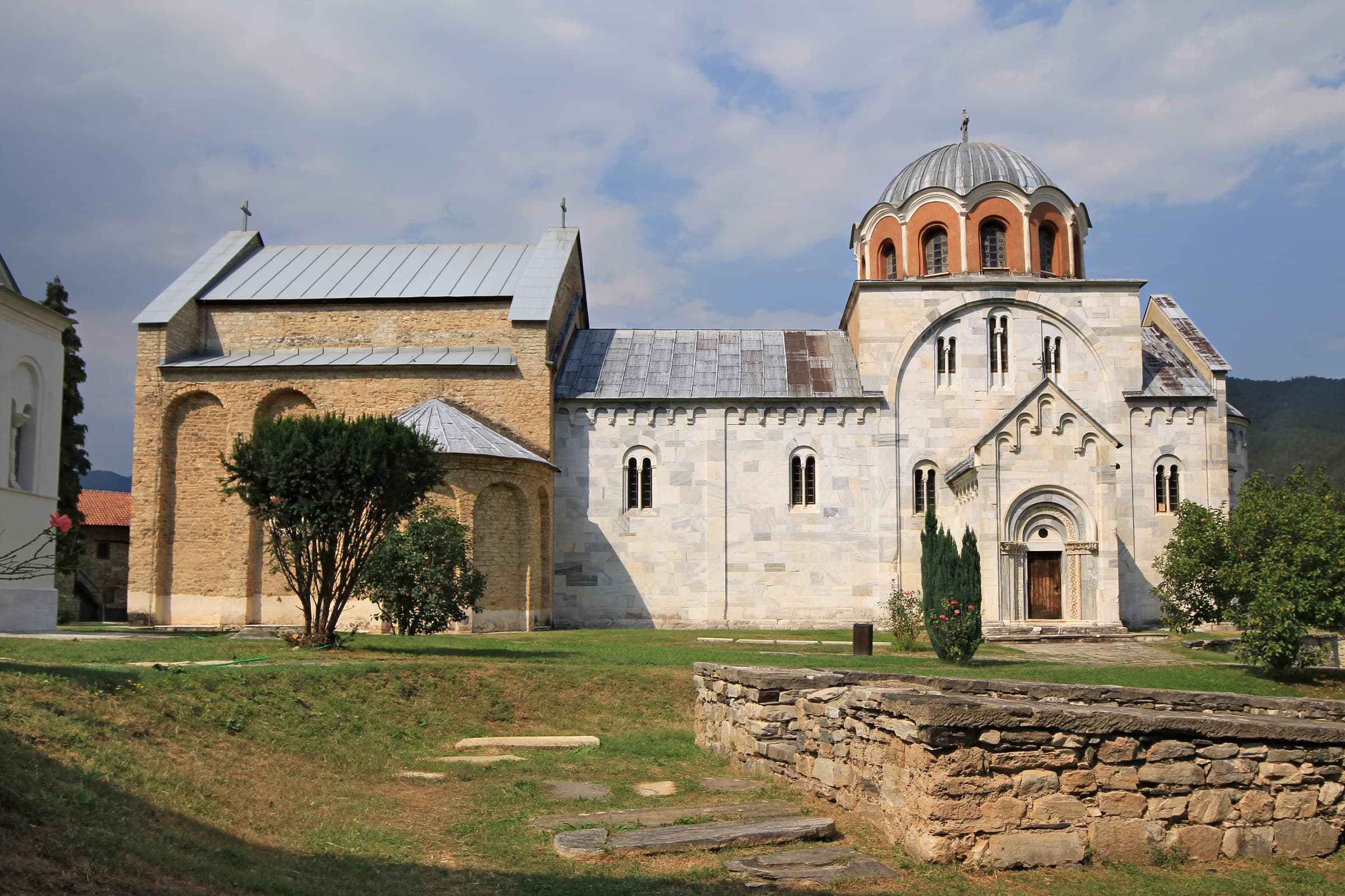 The white marble Church of the Virgin at Studenica Monastery within its circular stone walls