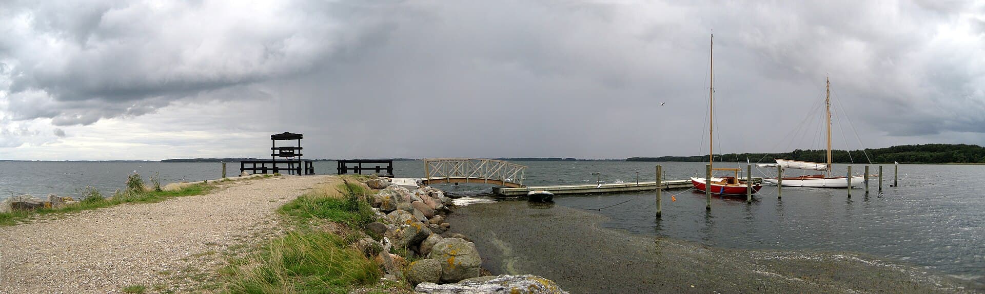 Wooden pier and harbour vistas near historic Valdemars Slot in the South Funen Archipelago.