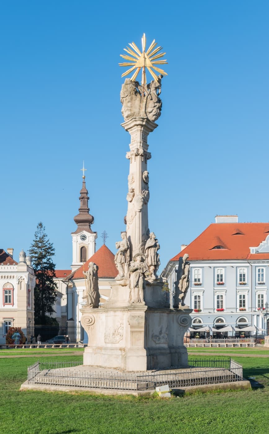 The colourful Baroque facades of Union Square (Piața Unirii) in Timișoara bathed in warm morning light
