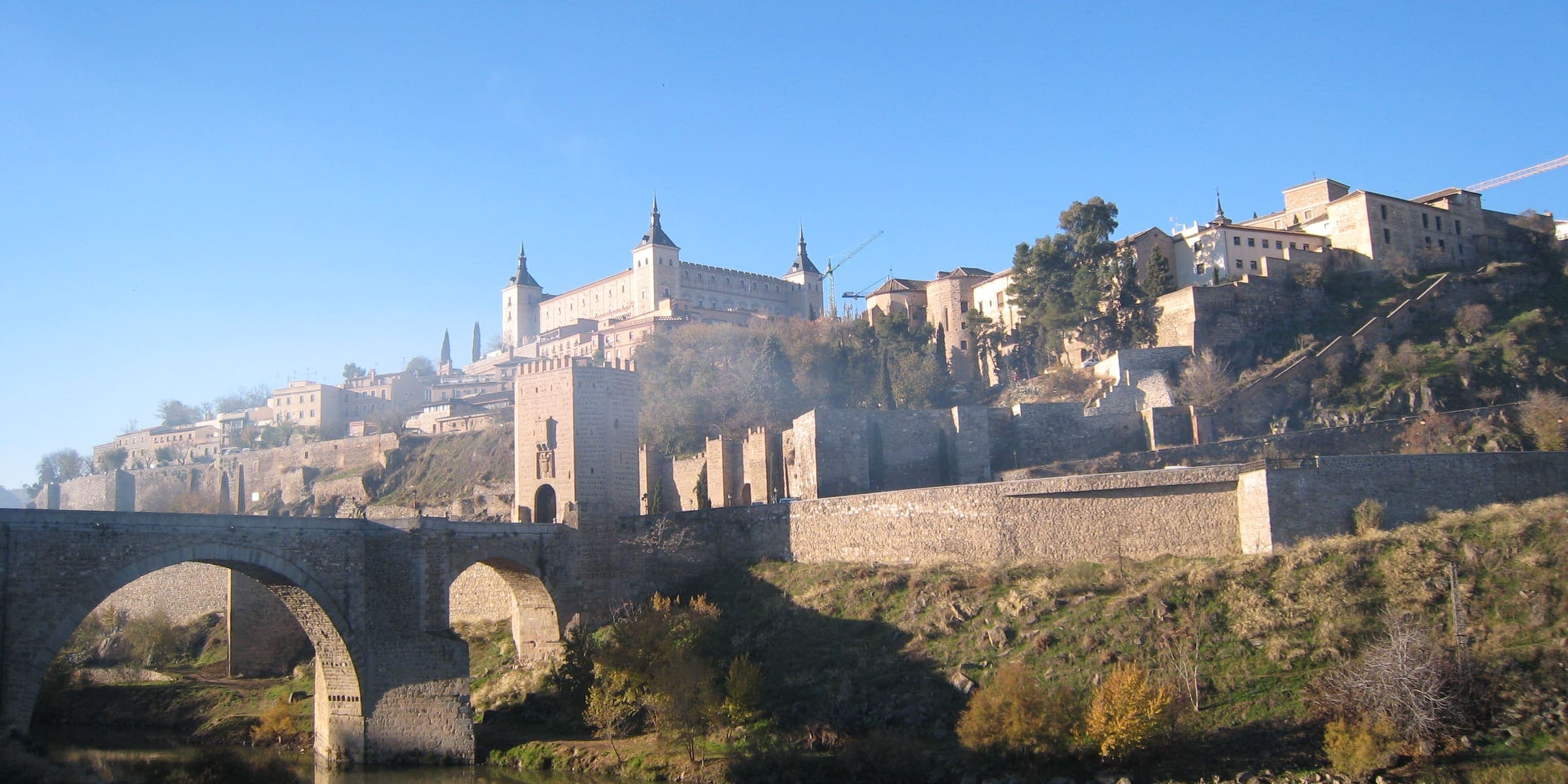 Toledo's Alcázar and old town above the Alcántara bridge and the Tagus