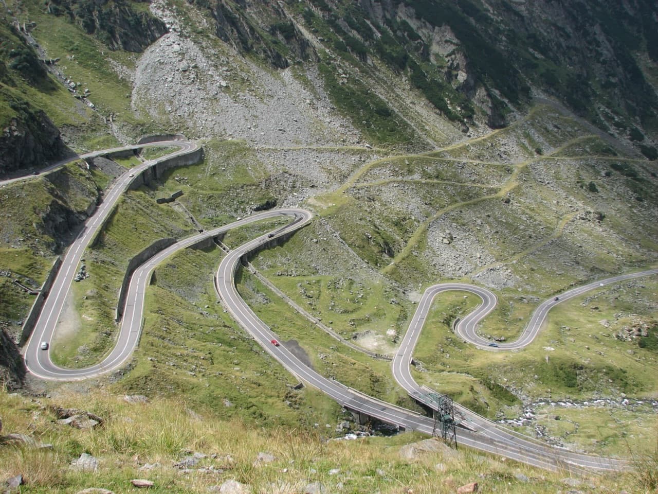 The dramatic sweeping hairpin turns of the Transfăgărășan highway climbing through the rugged Făgăraș Mountains