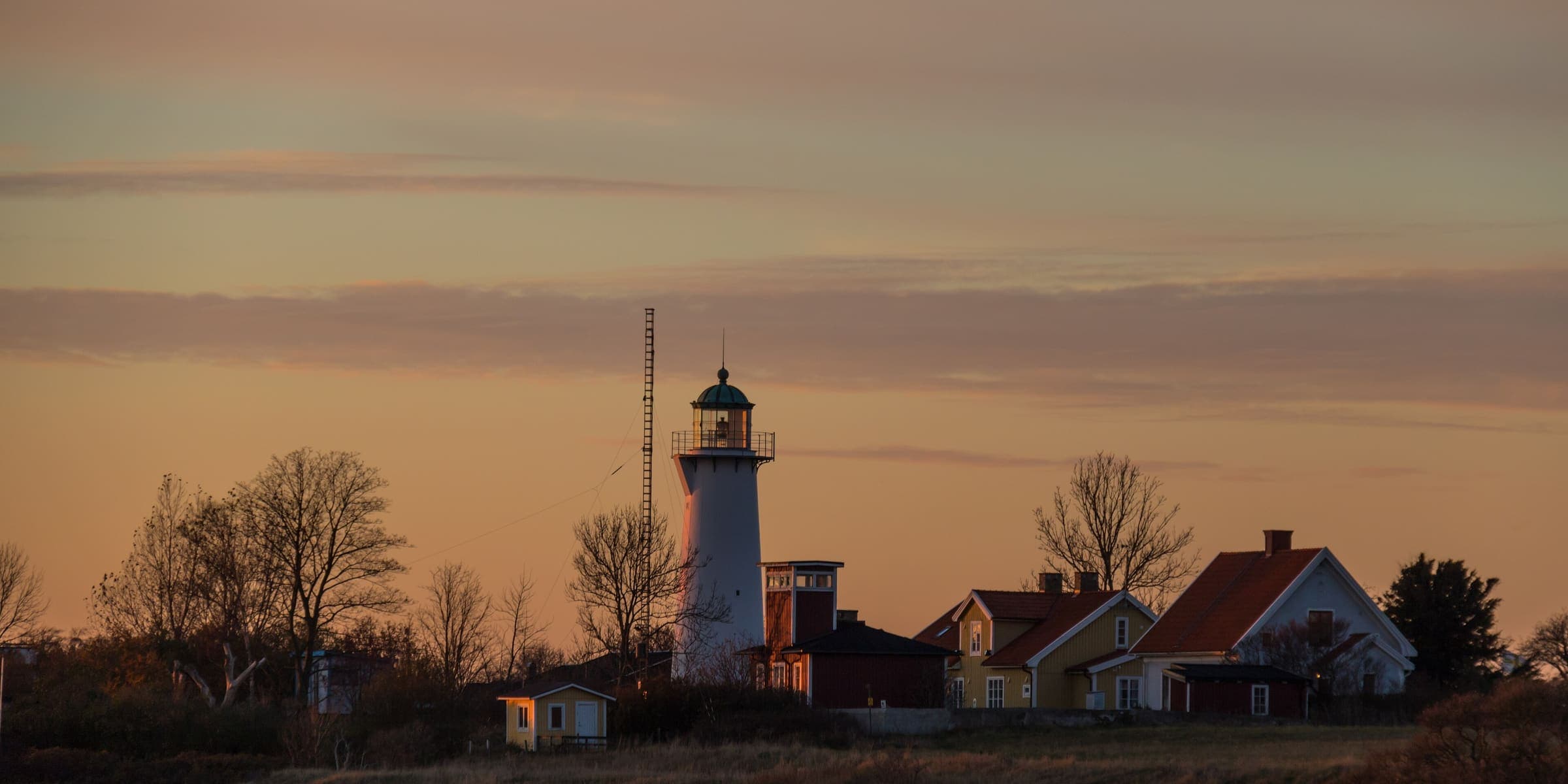 Smygehuk lighthouse and the fishing village at dusk, Sweden's southernmost point