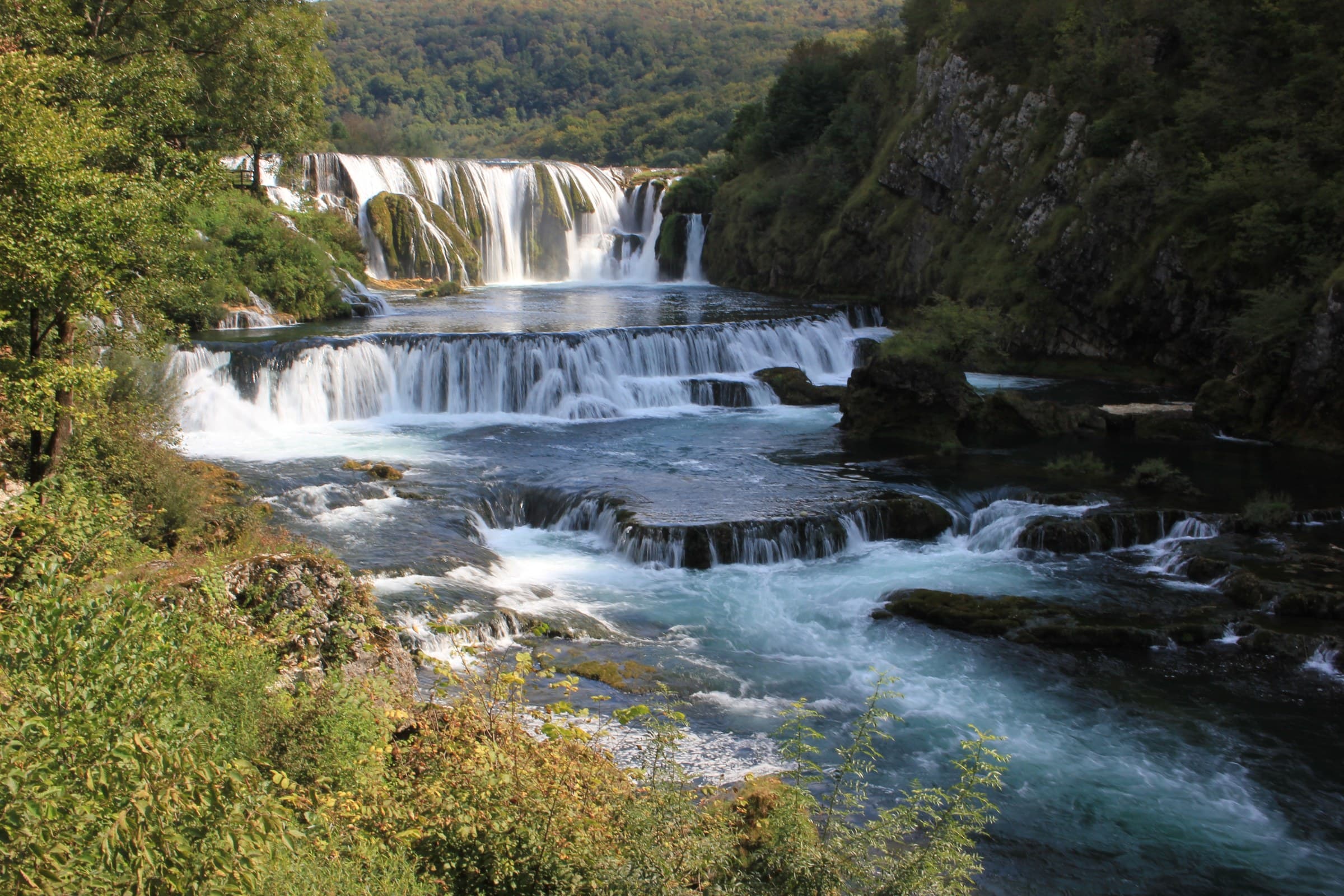 Dramatic multi-tiered roaring cascades of Štrbački Buk waterfall on the emerald Una River in Una National Park