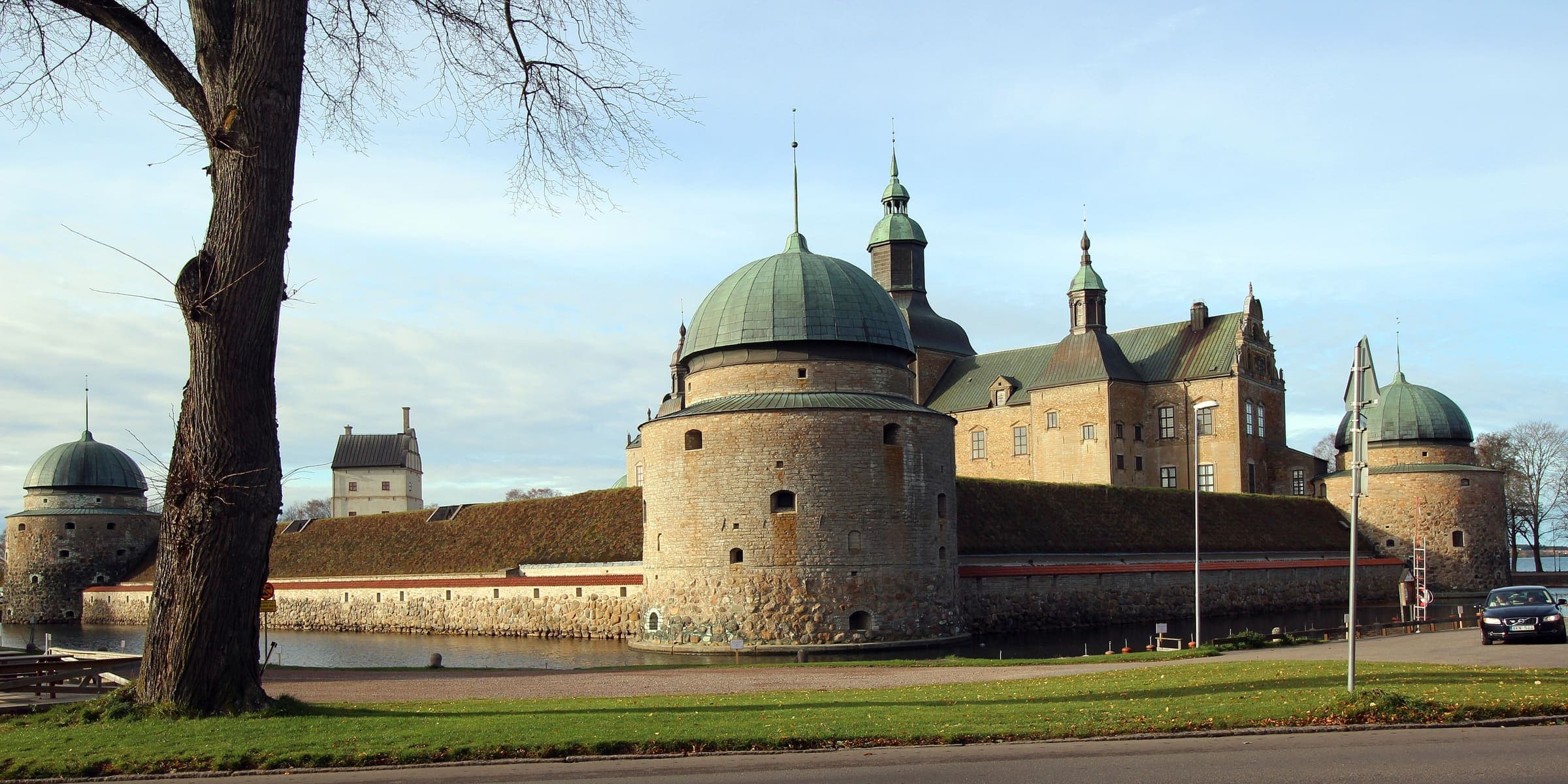 Vadstena Castle's domed round tower and moat on the shore of Lake Vättern