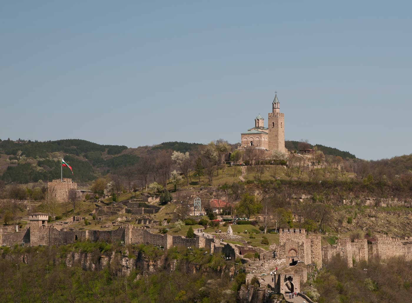 The medieval stone walls and Baldwin's Tower of Tsarevets Fortress rising above the Yantra River in Veliko Tărnovo
