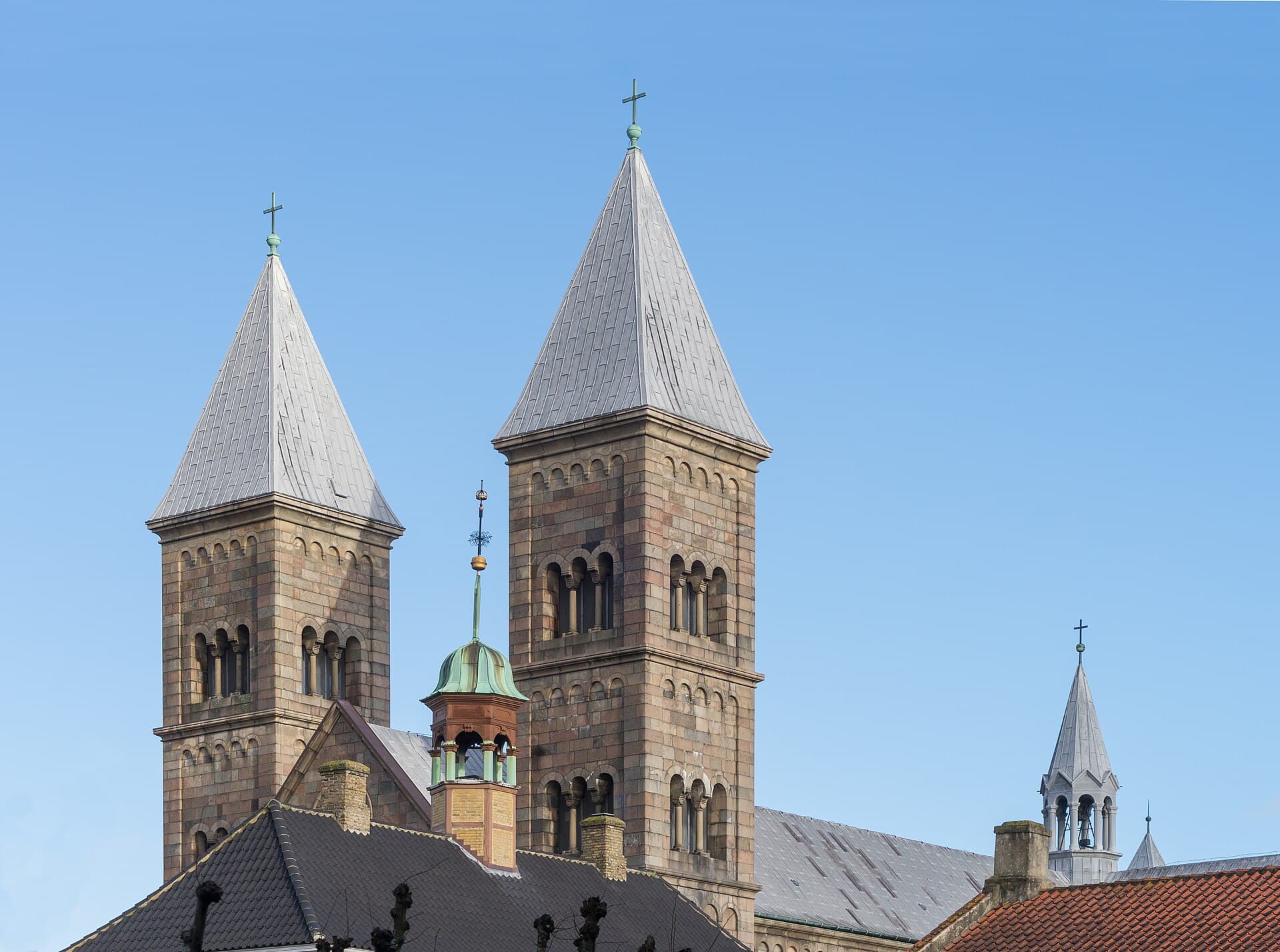 Twin granite towers of Viborg Cathedral overlooking historic cobblestone squares in central Jutland.
