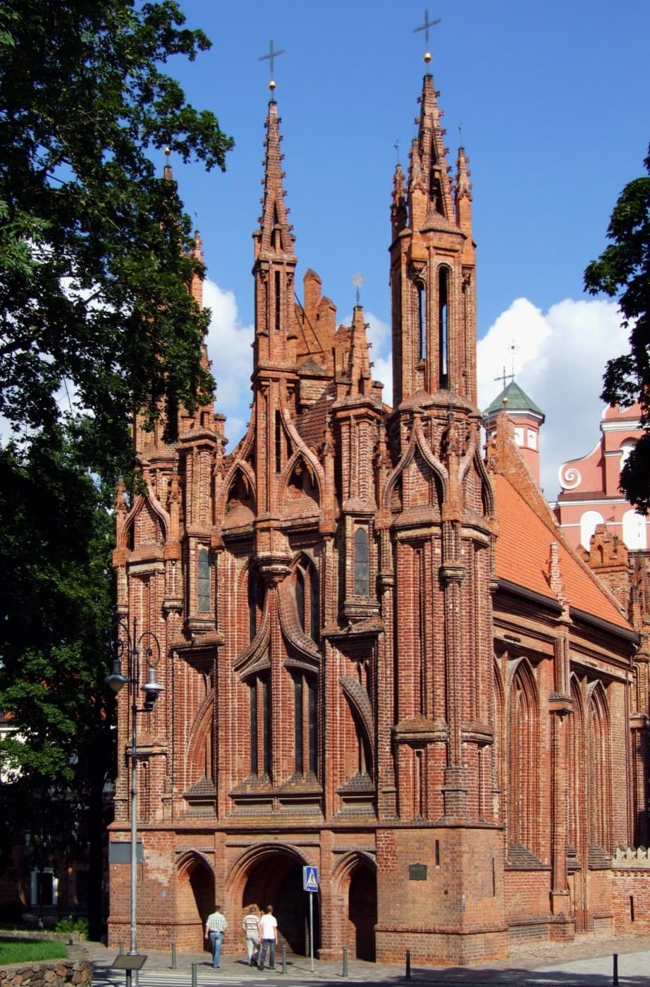 Terracotta rooftops, baroque church towers and green hills of Vilnius Old Town