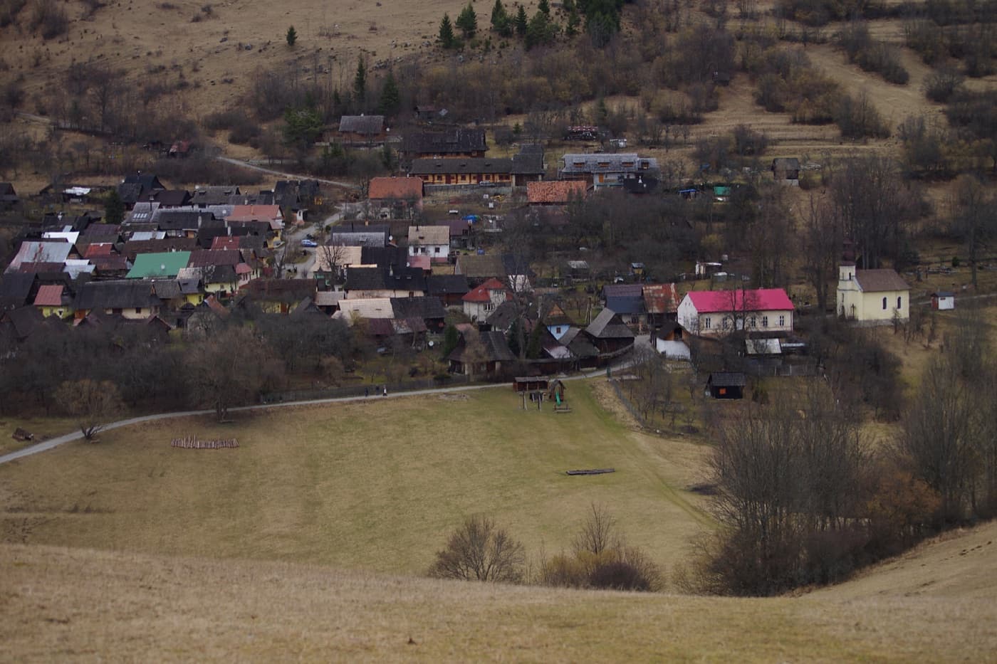 Colourful traditional wooden log cottages of Vlkolínec nestled on the green slopes of the Greater Fatra mountains