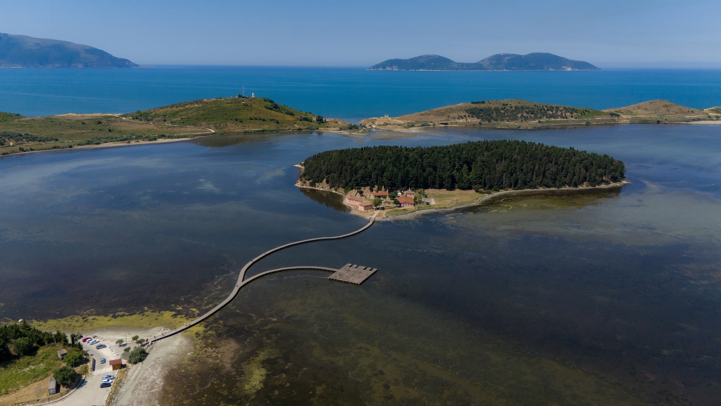 The wooden footbridge and Byzantine monastery of Saint Mary on Zvërnec island in Narta lagoon near Vlorë