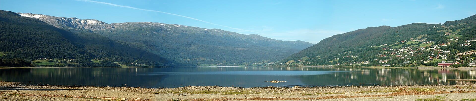 Vossevangen and Mount Hanguren reflected in the waters of Lake Vangsvatnet in Voss.