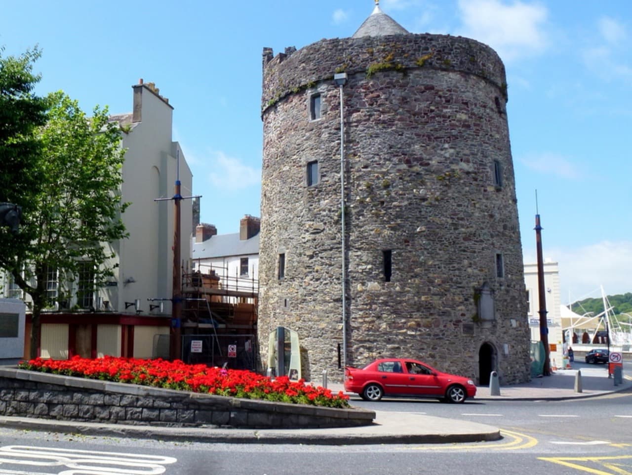 The stone cylinder of Reginald's Tower anchoring the historic Viking Triangle on the river quay in Waterford