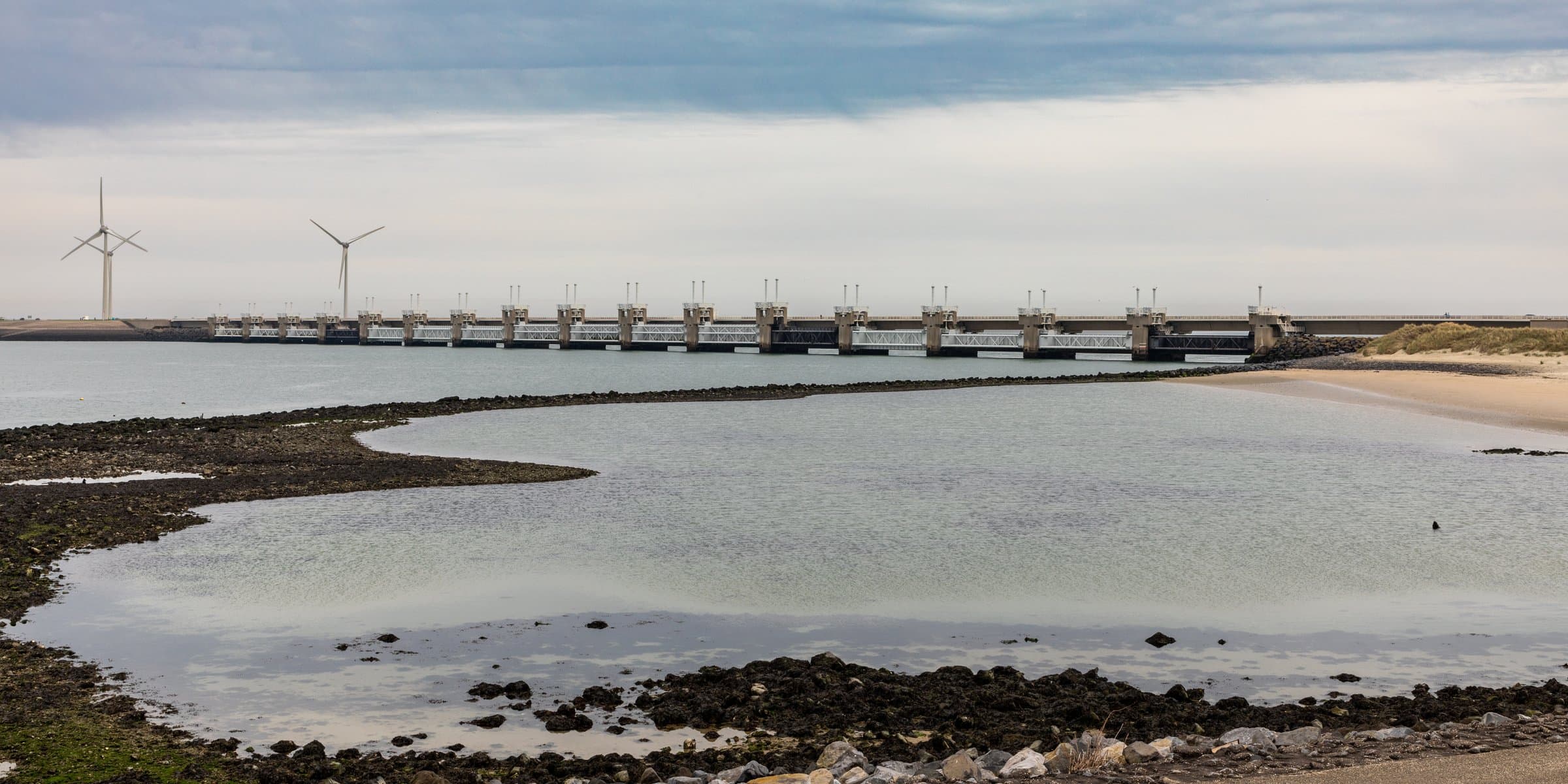 The colossal concrete storm surge sluice gates of the Oosterscheldekering Delta Works spanning the sea in Zeeland