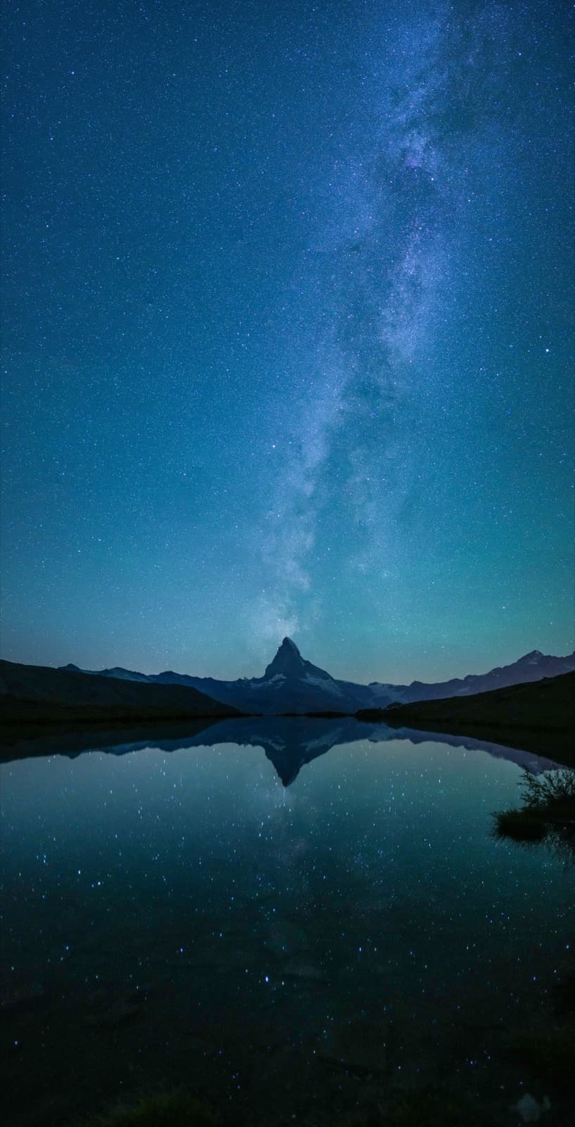 Night sky and the iconic peak of the Matterhorn reflected in Stellisee