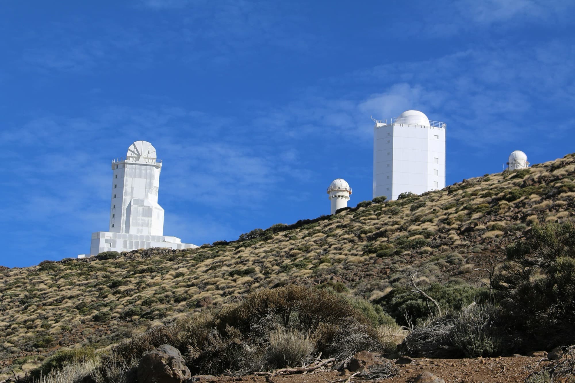 Observatory domes on the volcanic plateau of Izaña beneath the clear mountain sky