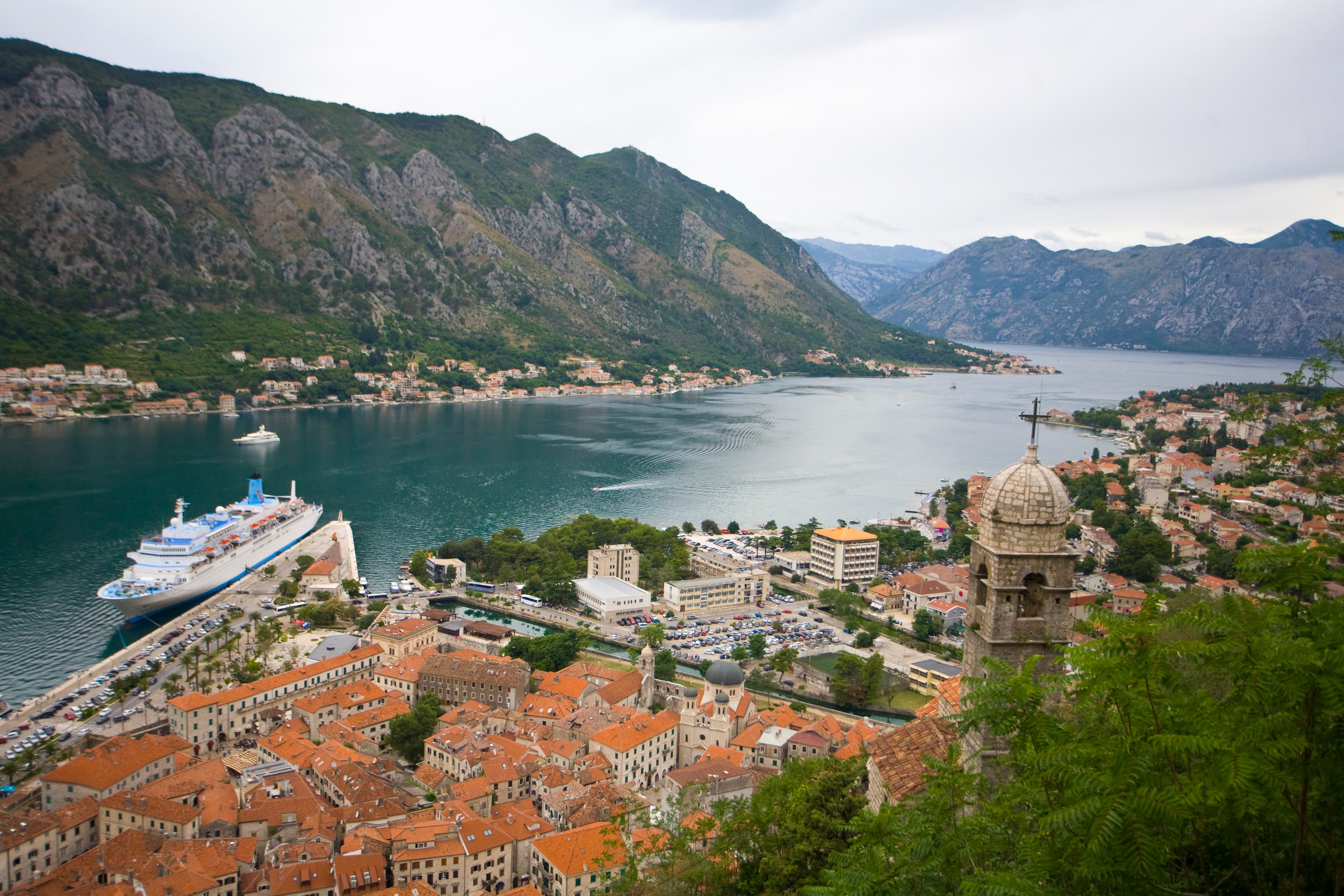 Sweeping panoramic view of the Bay of Kotor and terracotta roofs from the high walls of San Giovanni Fortress