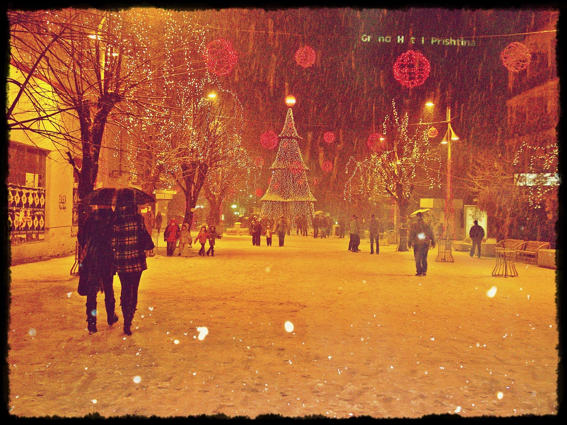 Mother Teresa Square in Pristina with people walking on the pedestrian boulevard