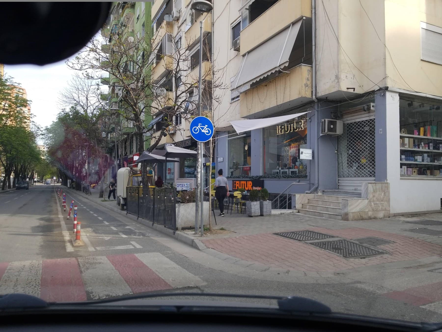 Bustling outdoor café terrace in Tirana's vibrant Blloku neighbourhood framed by modern buildings