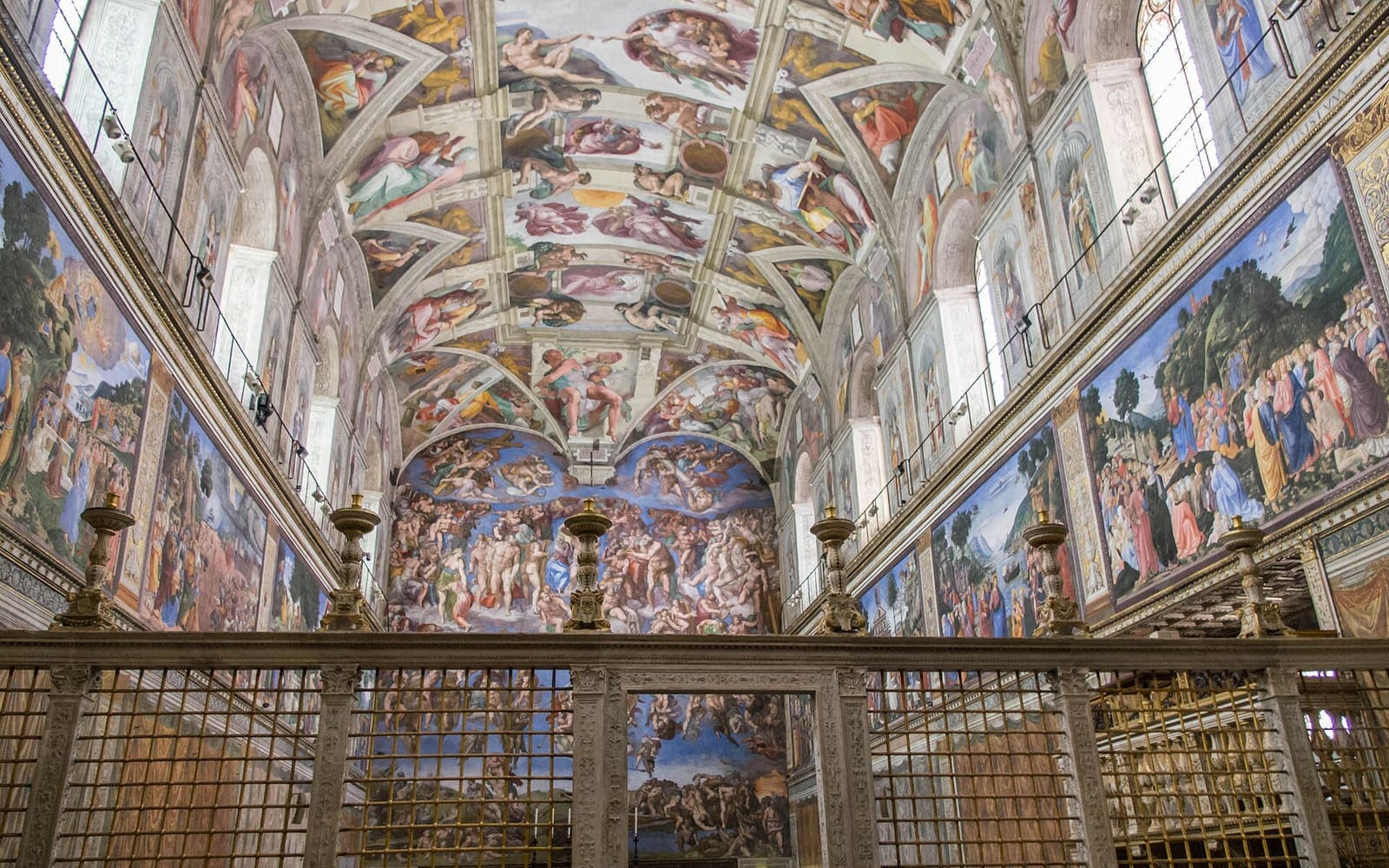 The painted ceiling and walls of the Sistine Chapel