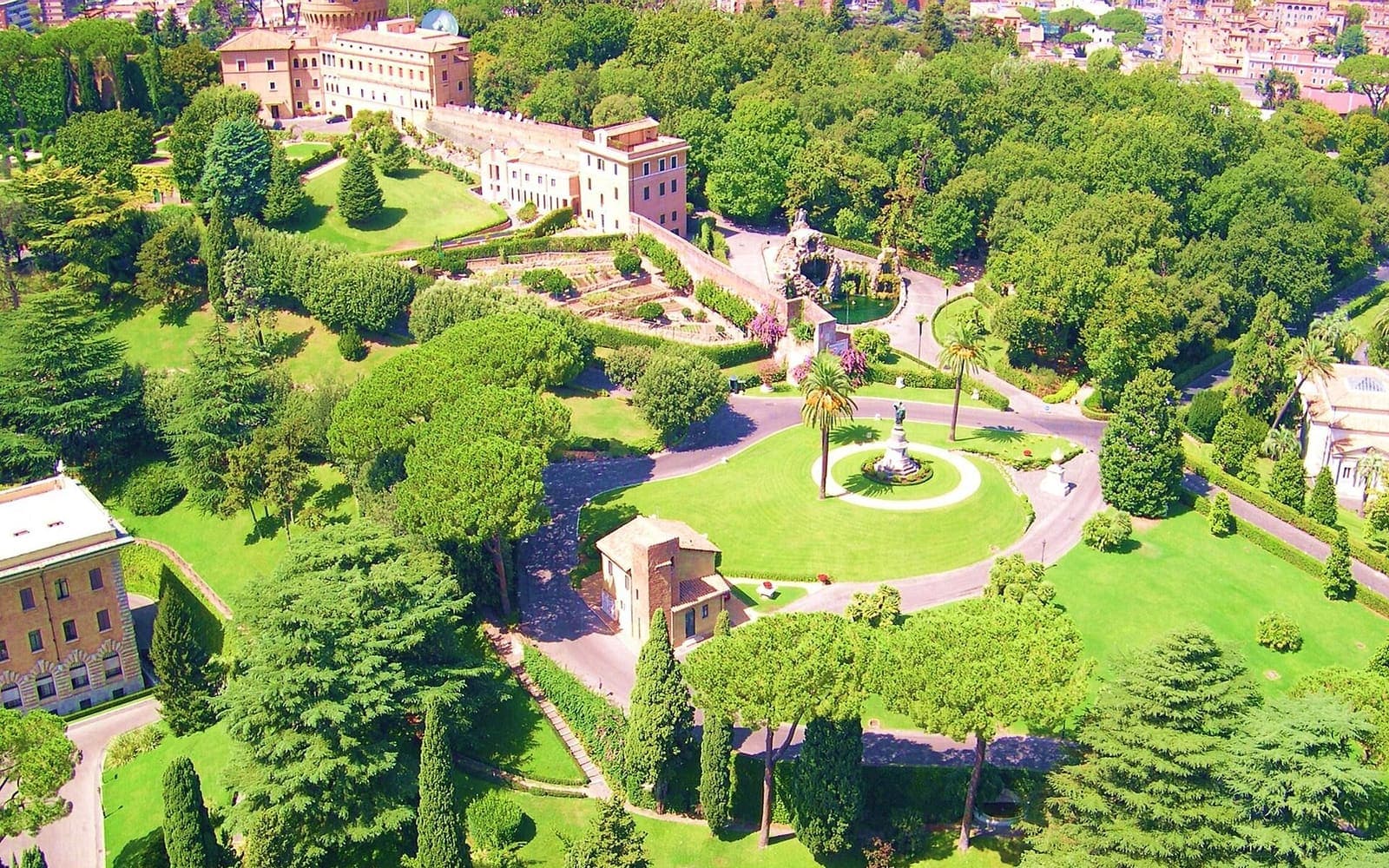 The formal lawns and trees of the Vatican Gardens seen from above