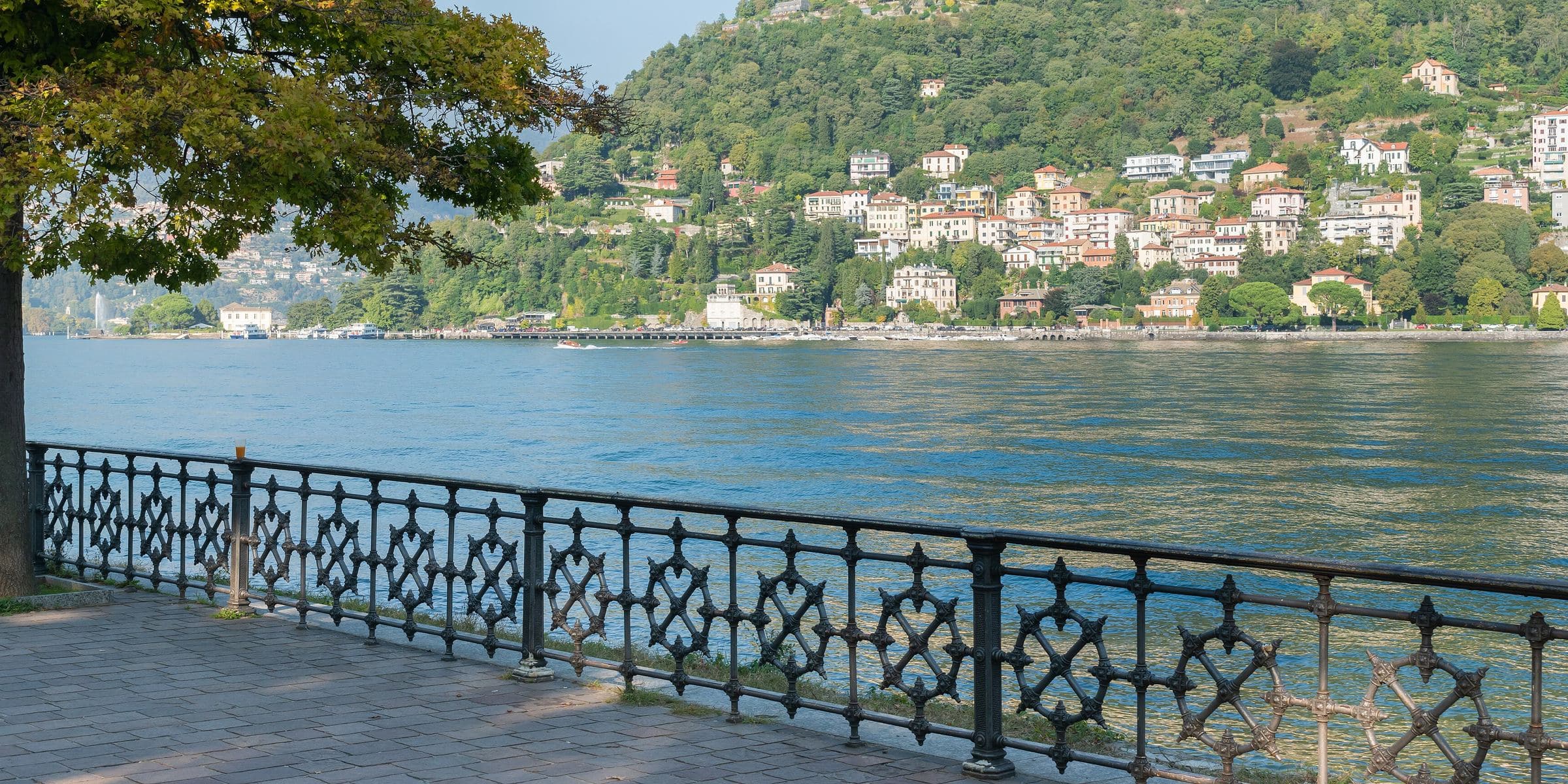 Lake Como and the hillside villas seen from the lakefront in Como