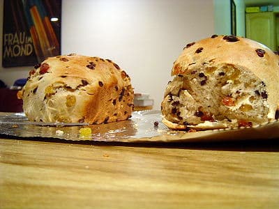 Thick slice of toasted traditional dried fruit bread spread with butter