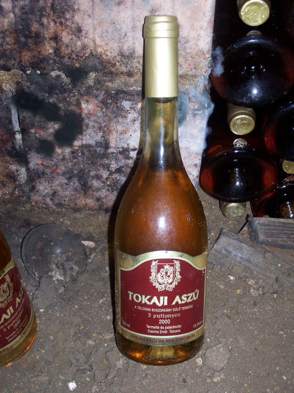 Amber glasses of sweet Tokaj wine aging in historical tuff rock cellars of eastern Slovakia